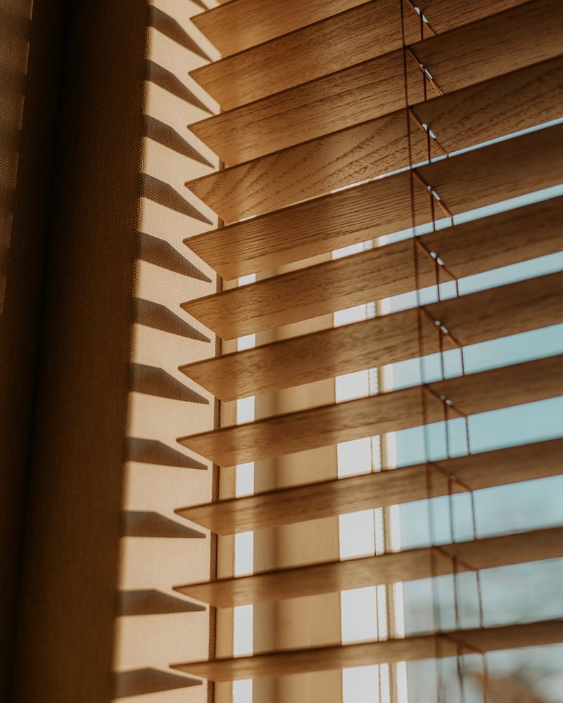 Warm afternoon light through wood blinds